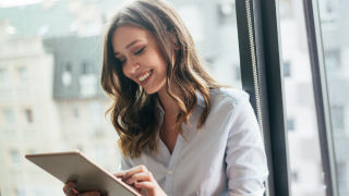 smiling woman on tablet