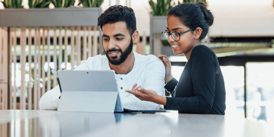 Couple looking at tablet smiling