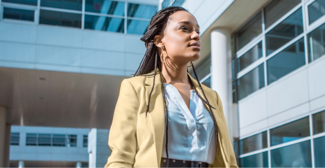 woman in beige blazer walking confidently