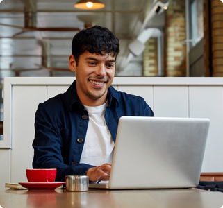 man looking at computer while smiling