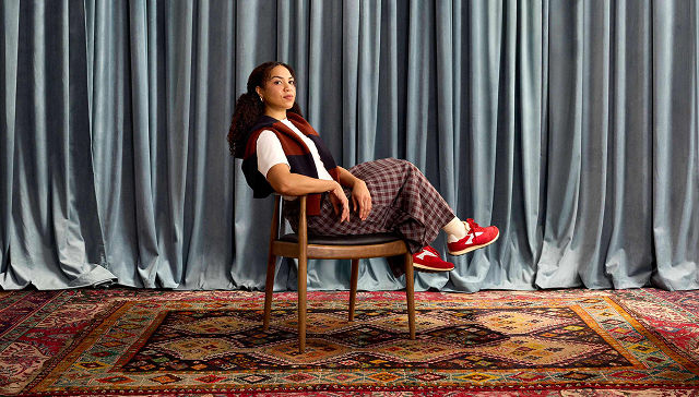 woman confidently leaning back in a wooden chair
