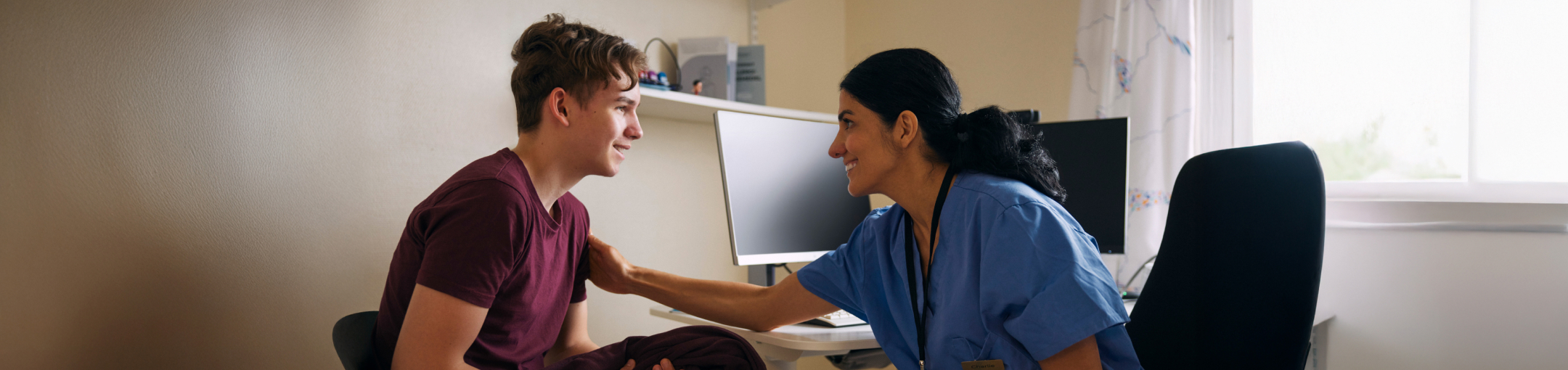 nurse reassuring a male patient