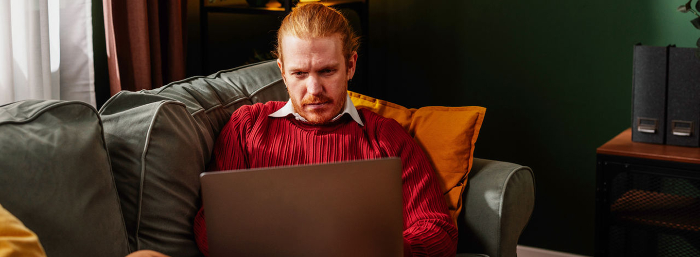 Portrayal of a Capella student studying at home on a sofa