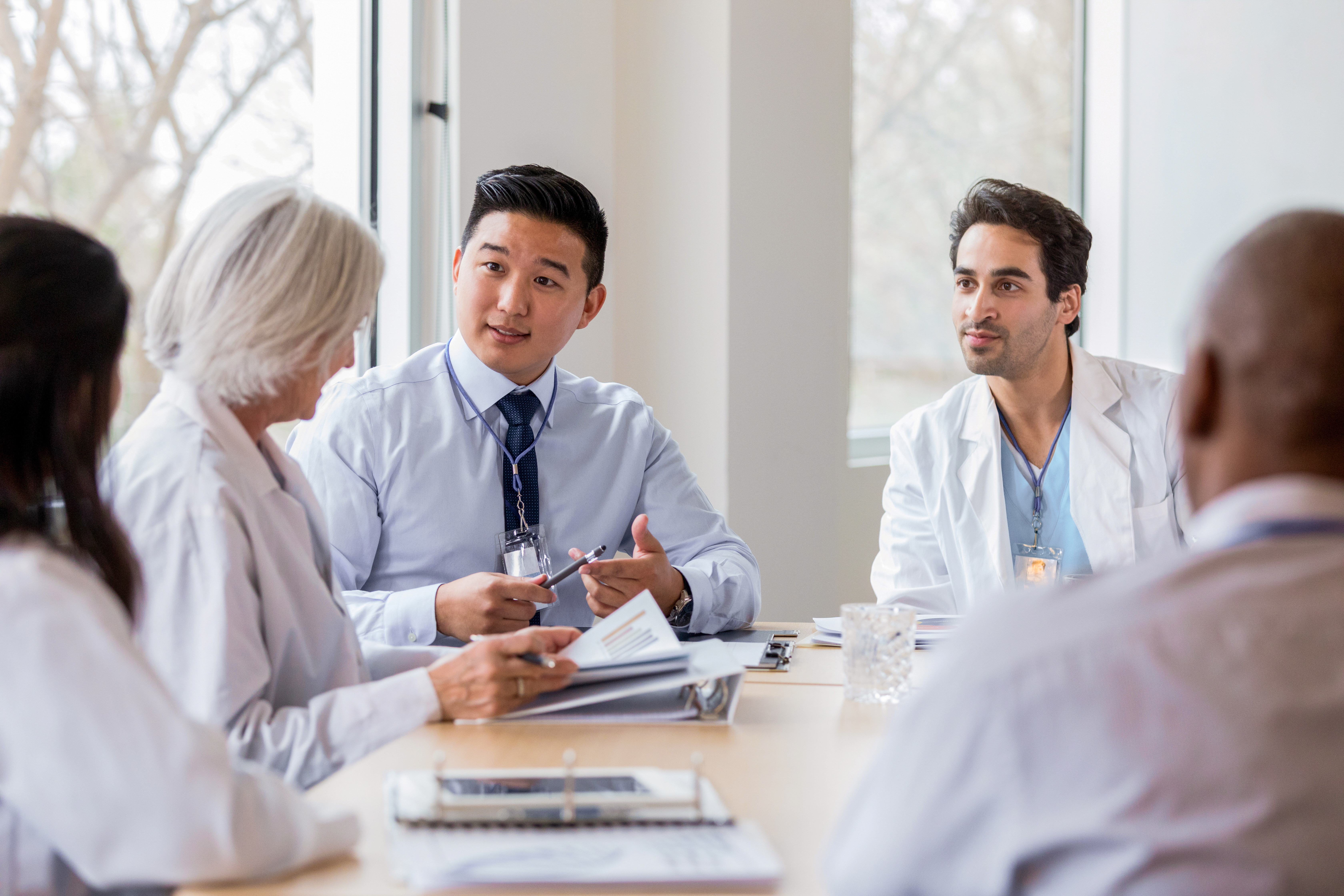 Portrayal of a Capella University Master of Public Health alum talking with doctors