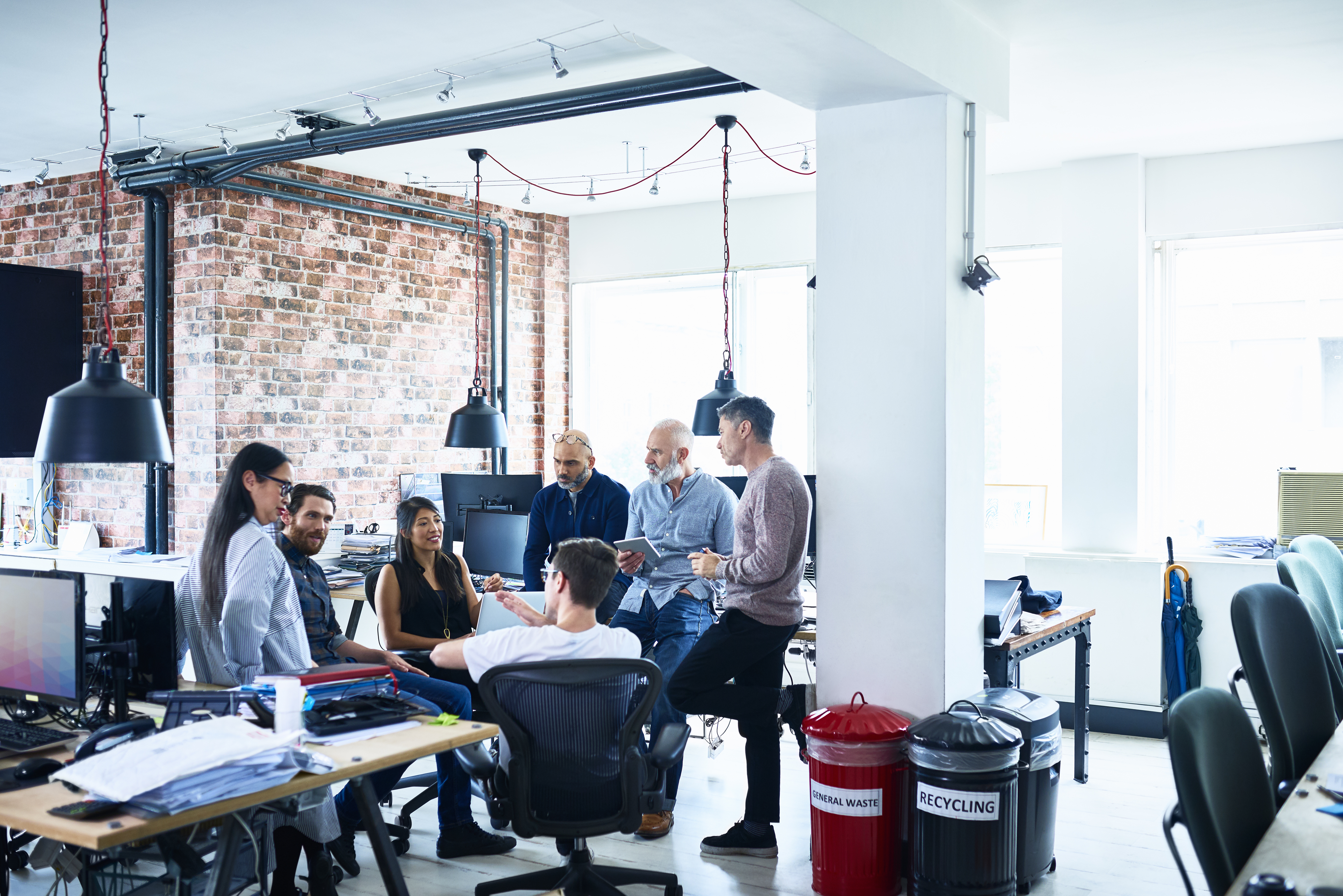 Portrayal of Capella business management student building consensus with colleagues