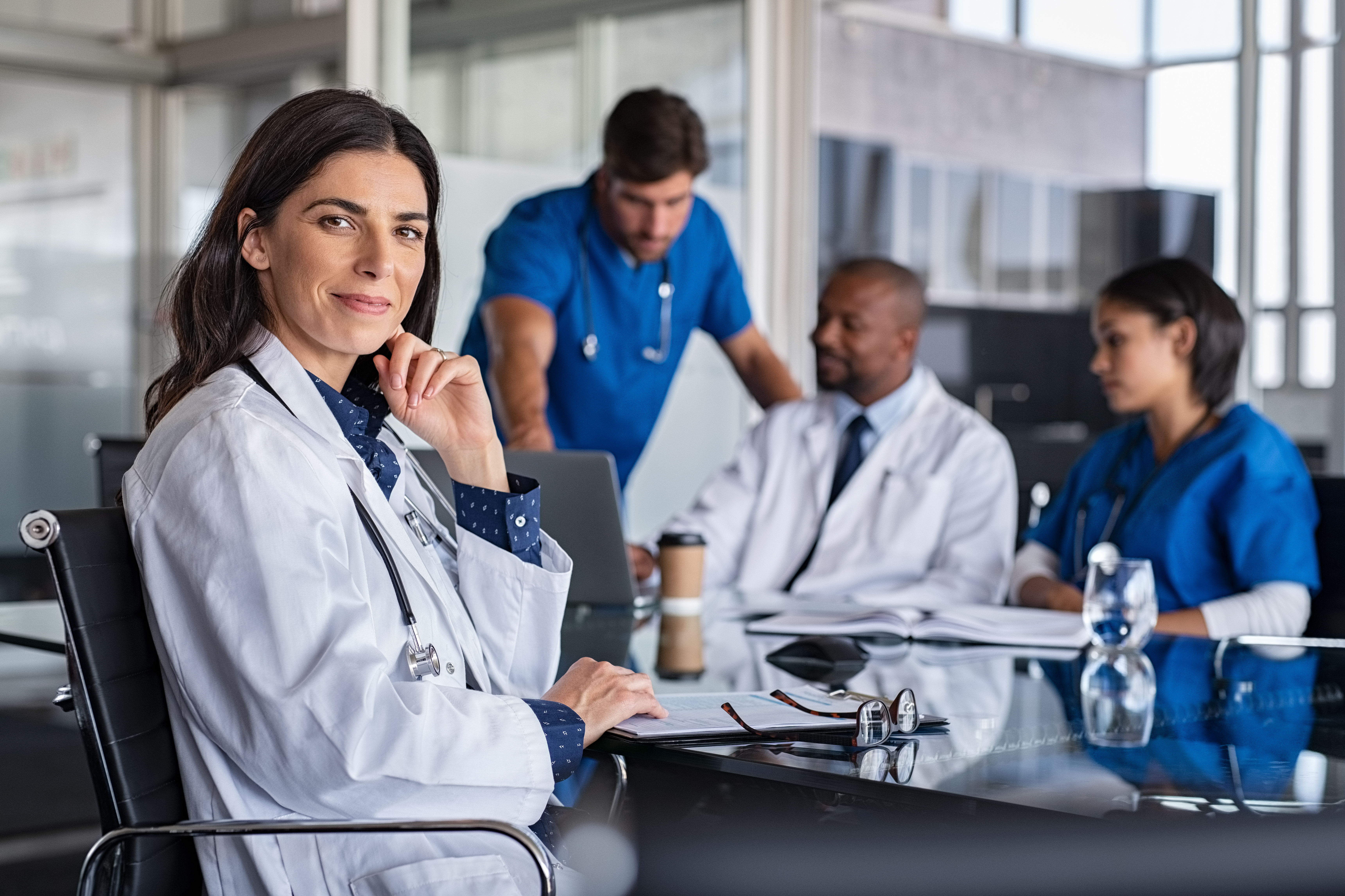 Portrayal of Capella DrPH graduates collaborating in a medical facility.