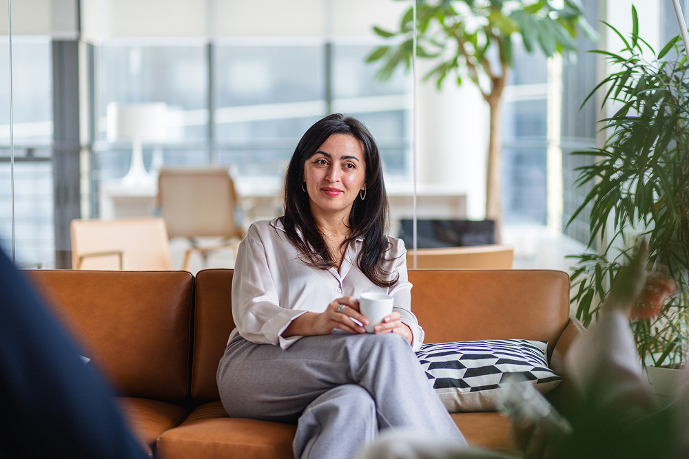 Portrayal of a Capella University online MBA student in an office drinking coffee.