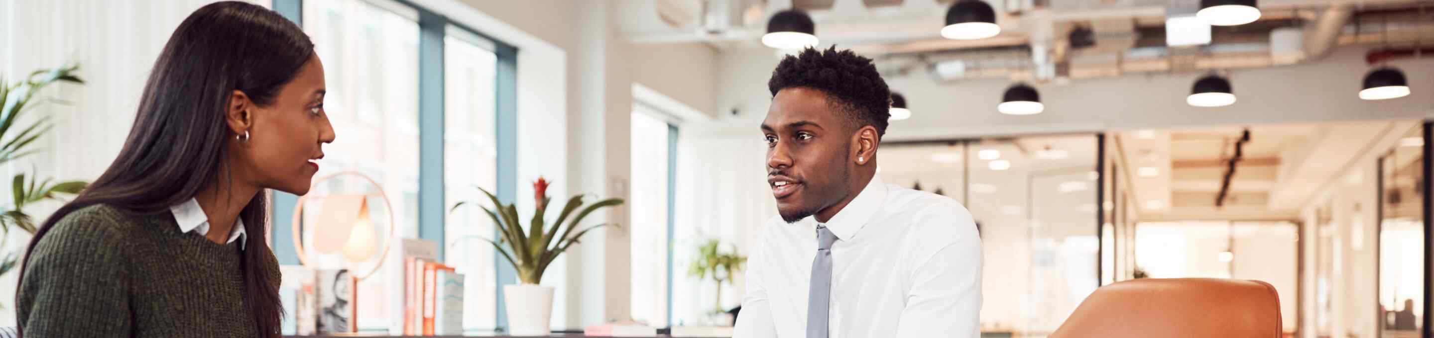 woman interviewing man in professional attire