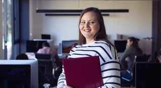  woman smiling while holding maroon folder