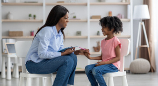  woman teaching young girl