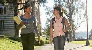 two women walking on a college campus