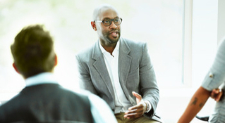 man speaking to his peers